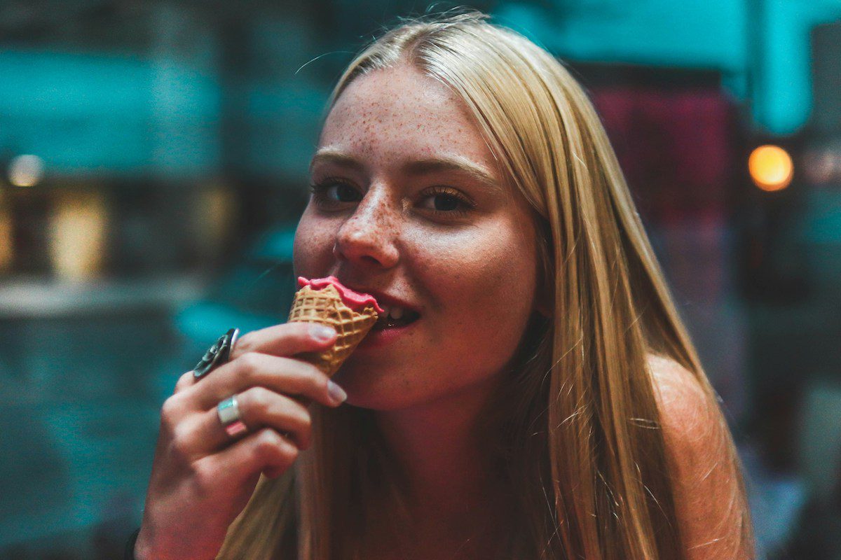 How to Help Sensitive Teeth - girl biting icecream